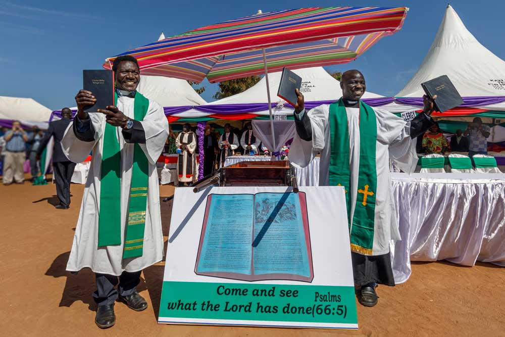 Pastors hold up new Bibles